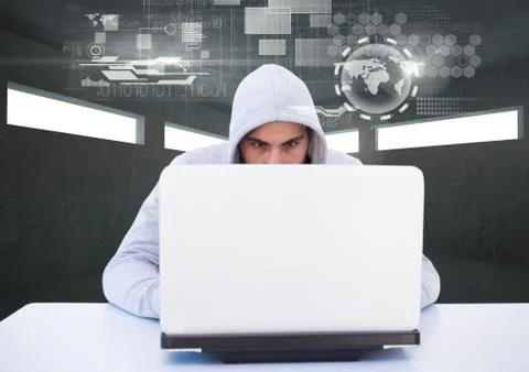 Hacker using a laptop in a dark room 写真素材