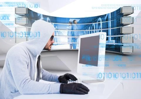 Hacker using a laptop in a data center Stock Photos