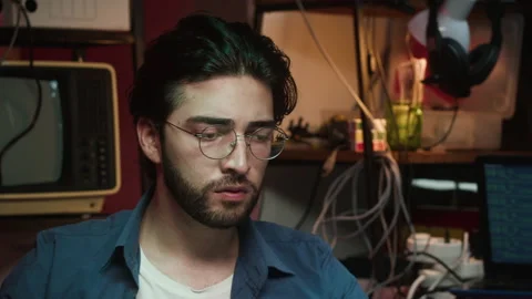 Hacker using laptop, drinking coffee close-up. Young Spanish man developing Stock-Footage 164414673
