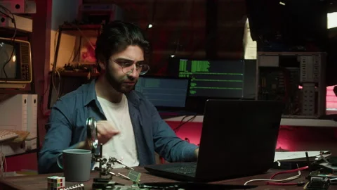 Hacker using laptop, drinking coffee close-up. Young Spanish man developing Stock-Footage 164490415