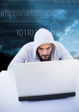 Hacker using a laptop in front of blue background with digital numbers Stock Photos