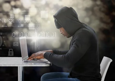 Hacker using a laptop in front of digital background Foto stock