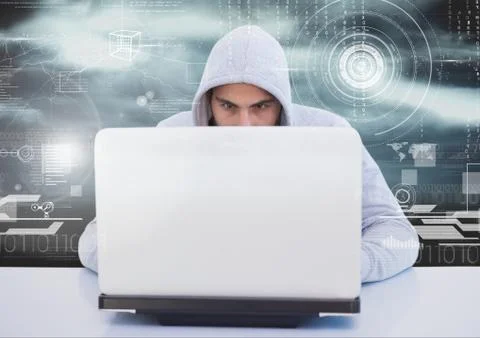 Hacker using a laptop in front of digital background Foto stock