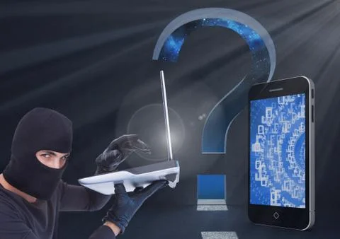 Hacker using a laptop in front of digital background with digital smartphone and Stock Photos