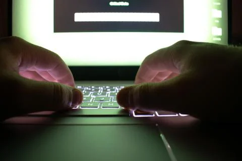 Hacker using laptop. Stock Photos
