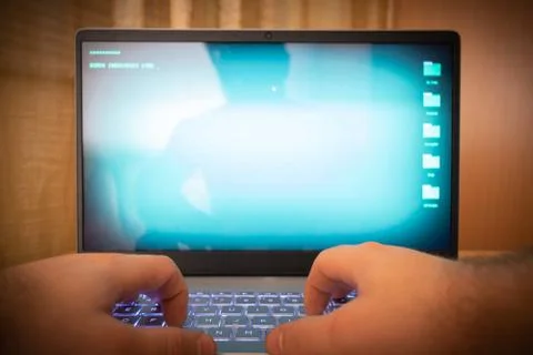 Hacker using laptop. Stock Photos