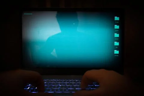 Hacker using laptop. Stock Photos