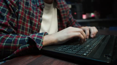 Hacker using laptop. Young man developing program close-up. Professional Stock Footage 167049375