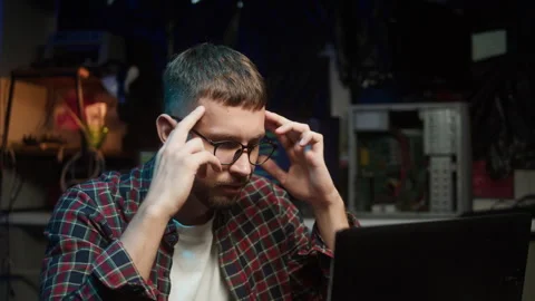 Hacker using laptop. Young man thinking about developing program. Professional Video stock 247660881