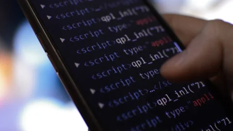 Hacker using phone for cyber attack. digital code on the iphone screen. Stock Footage 231222570
