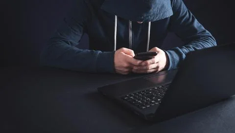 Hacker using smartphone. Cyber crime Stock Photos