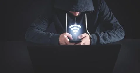 Hacker using smartphone with a wifi symbol. 스톡 사진