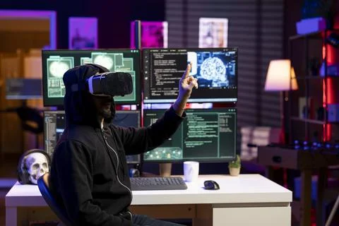 Hacker using virtual reality and with exploits on computer to break into systems Stock Photos