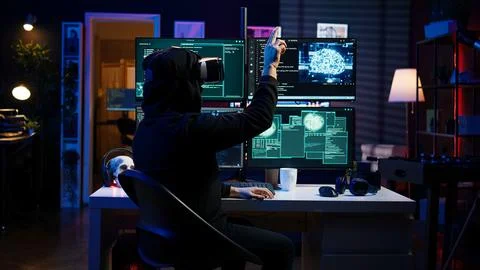 Hacker using virtual reality headset to code malware 스톡 사진