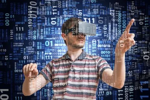 Hacker is wearing 3D virtual reality glasses and is hacking binary code. Stock Photos