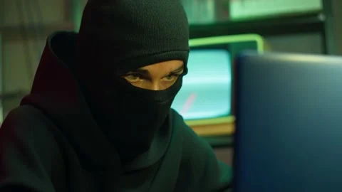 Hacker wearing balaclava stealing information from laptop, breaking password and Stock Footage 158385354