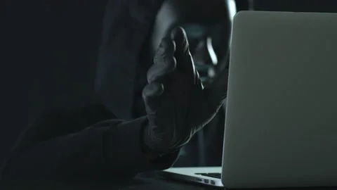 Hacker wearing black mask pulls DARKNET tab from a laptop Stock Footage 138143572
