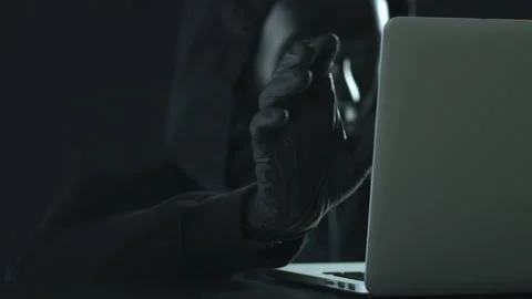 Hacker wearing black mask pulls ACCESS tab from a laptop Stock Footage 138143753