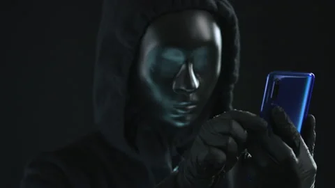 Hacker wearing black mask pulls PASSCODE tab from a smartphone. Hacking concept Video stock 138255104