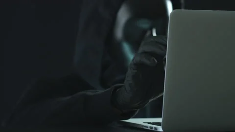 Hacker wearing black mask pulls SOURCE CODE tab from a laptop. Hacking concept Stock Footage 138345334