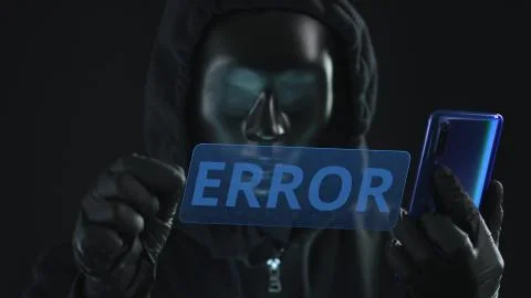 Hacker wearing black mask pulls ERROR tab from a smartphone. Hacking concept Foto stock