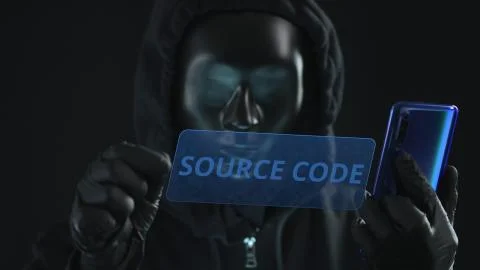 Hacker wearing black mask pulls SOURCE CODE tab from a smartphone. Hacking Stock Photos