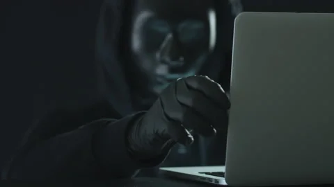 A hacker wearing black pulls CODE tab from a laptop. Hacking concept Stock Footage 138943065