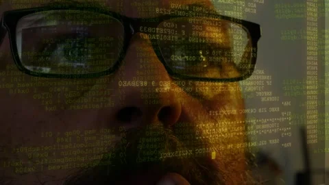 Hacker wearing glasses watching lines of code and data scanning displayed on Stock Footage 342076156