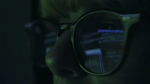 Hacker wearing Glasses Working on Computer, Code is reflected in his eyes Stock Footage 151412956