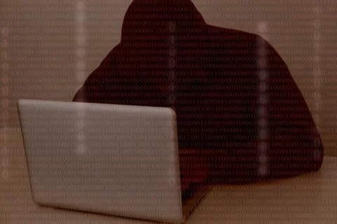 Hacker wearing a hooded top using laptop computer in the dark. The man breaks 스톡 사진