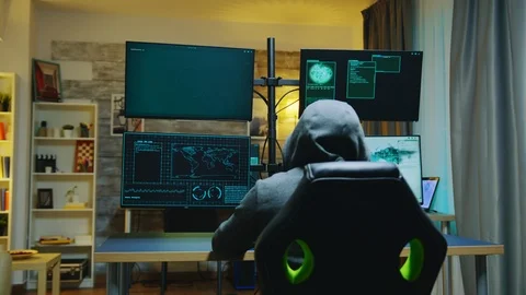 Hacker wearing a hoodie while committing cyber crimes 스톡 동영상 125386598