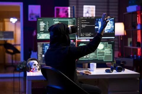 Hacker wearing VR headset uses AI machine learning to develop exploit Stock Photos