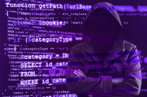 Hacker without face surrounded by source code Stock Photos
