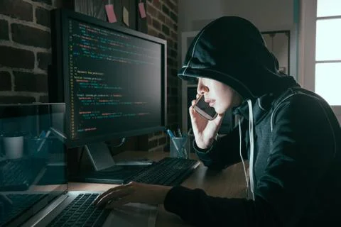 Hacker woman hidden face using mobile cell phone 스톡 사진