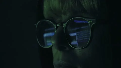 Hacker working on computer Code is reflected on his eyeglasses. Programmer Stock Footage 151412970