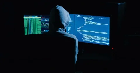 Hacker is working on computer in cyber security center filled with display Stock Footage 82916154