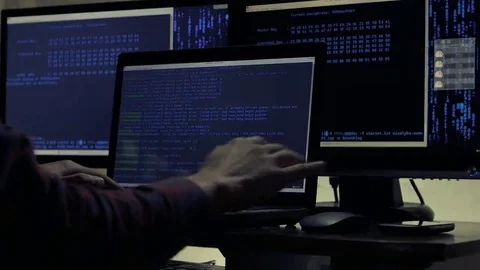 Hacker working on a computer in a dark office room Stock Footage 69072494