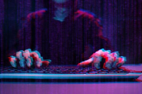 Hacker working with computer in dark room with digital interface around. Image Stock Photos
