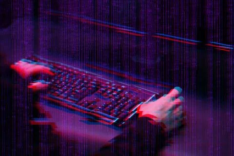 Hacker working with computer in dark room with digital interface around. Image Foto stock