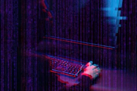 Hacker working with computer in dark room with digital interface around. Image Stock Photos