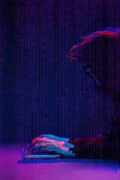 Hacker working with computer in dark room with digital interface around. Image Foto stock