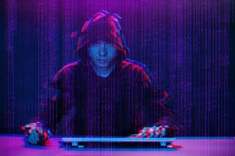 Hacker working with computer in dark room with digital interface around. Image Stock Photos
