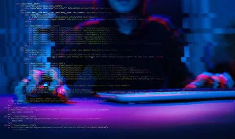 Hacker working with computer in dark room with digital interface around. Image Stock Photos