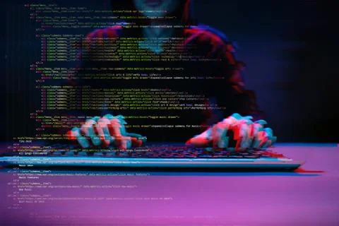 Hacker working with computer in dark room with digital interface around. Image Stock Photos