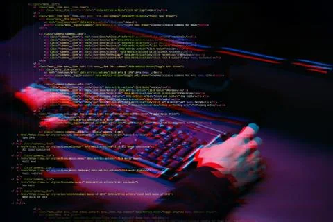 Hacker working with computer in dark room with digital interface around. Image Stock Photos