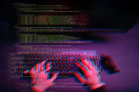 Hacker working with computer in dark room with digital interface around. Image Foto stock