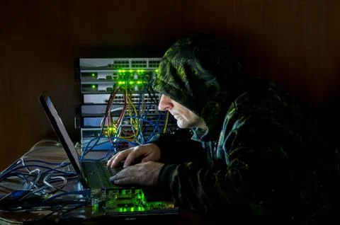 Hacker working on the computer with hacker tools Stock Photos