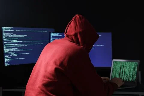 Hacker working with computers in dark room. Cyber attack 库存照片