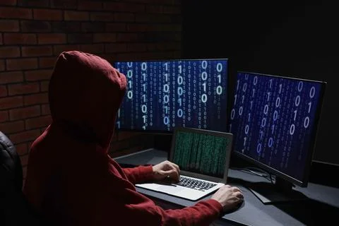 Hacker working with computers in dark room. Cyber attack Stock Photos