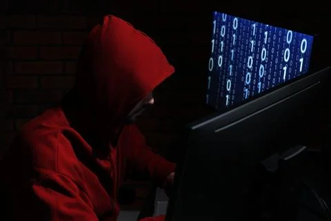 Hacker working with computers in dark room. Cyber attack Stock Photos